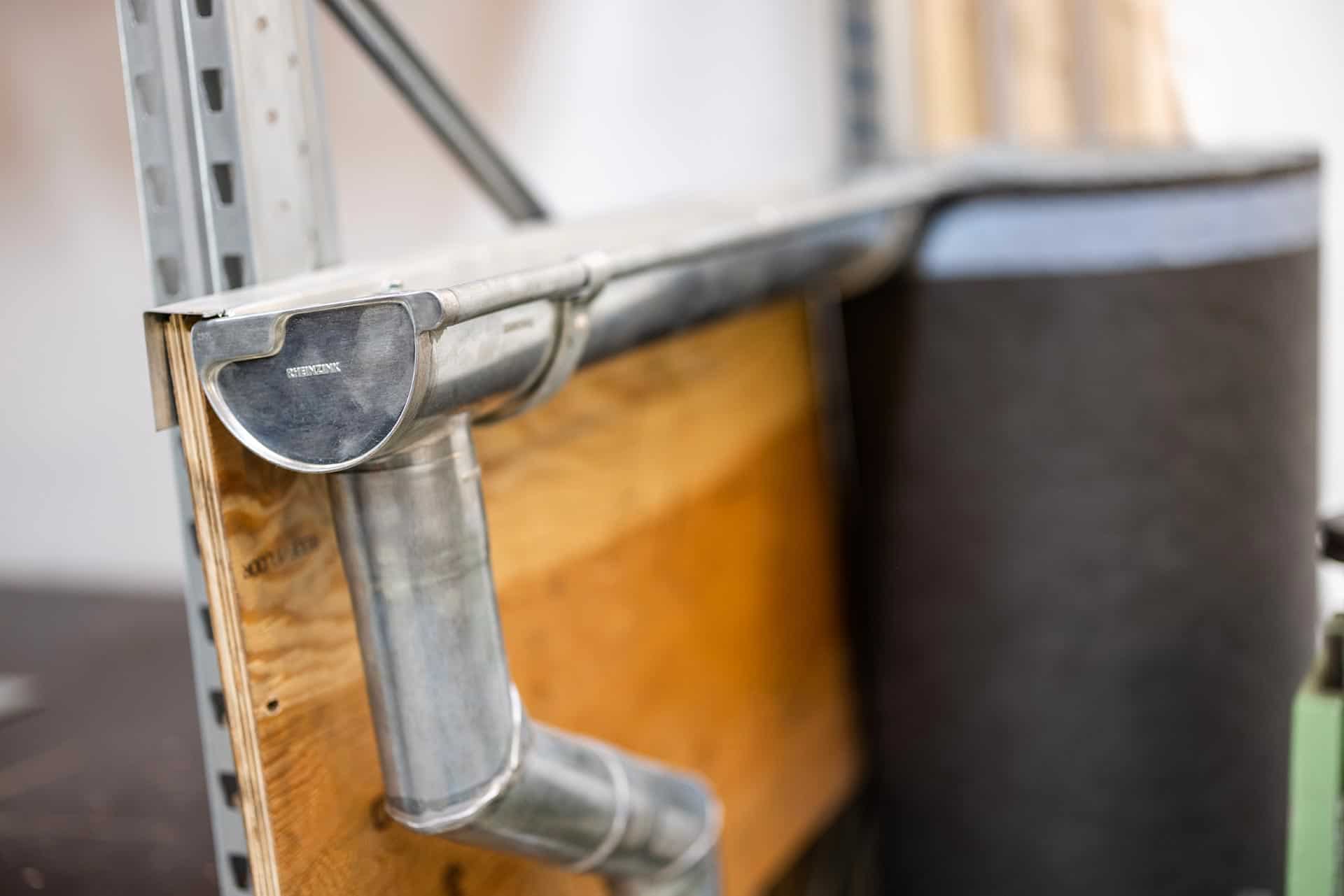 En mand i sortklædt tøj, som står ved et arbejdsbord. Han arbejder for Bjærre VVS i Hornbæk.